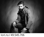 Portrait of handsome man with beard and mustache. Close-up image of serious brutal bearded man on dark background. Black and white photography. Стоковое фото, агентство Ingram Publishing / Фотобанк Лори