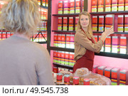 cheerful female pharmacist with biologically active dietary supplement package. Стоковое фото, агентство Ingram Publishing / Фотобанк Лори