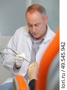 podiatry doctor treating patients foot. Стоковое фото, агентство Ingram Publishing / Фотобанк Лори