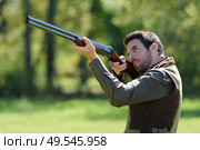 hunter with gun aiming at something. Стоковое фото, агентство Ingram Publishing / Фотобанк Лори