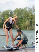 cool girl wakeboarding cutting water surface with hand. Стоковое фото, агентство Ingram Publishing / Фотобанк Лори
