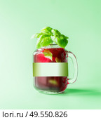Red refreshing berries beverage in glass jar with green white branding mock up and mint leaves at sunny bight mint background. Summer mood. Blank Label at juice bottle. Healthy drinks. Стоковое фото, агентство Ingram Publishing / Фотобанк Лори