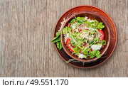 Green buckwheat vegetable salad with celery stalks, microgreens and spinach on wooden table.Copy space. Spring vegetable salad. Стоковое фото, агентство Ingram Publishing / Фотобанк Лори