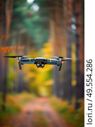 A small black and white plane flies over a dense forest, showcasing the contrast between man-made machinery and natural surroundings. Стоковое AI-изображение, AI-художник Данила Большаков / Фотобанк Лори