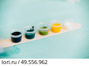 Little tattoo ink bottles full of different colors. Tattoo concept.. Little tattoo ink bottles full of different colors. Стоковое фото, агентство Ingram Publishing / Фотобанк Лори