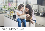 Mother and cute daughter whisking cake in the bowl. Стоковое фото, агентство Ingram Publishing / Фотобанк Лори