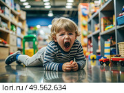 A little boy is lying on the floor in a store. Childish hysteria. The child screams, sobs, gets cranky and gets hysterical. Discontent. Стоковое AI-изображение, AI-художник Photojuli / Фотобанк Лори