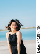 joyous happy girl in a black dress laughs loudly. Стоковое фото, агентство Ingram Publishing / Фотобанк Лори