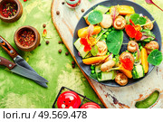 Salad with stewed mushrooms, cucumber,tomato and nasturtium.. Summer vegetable salad with flowers. Стоковое фото, агентство Ingram Publishing / Фотобанк Лори