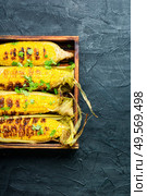 Grilled sweet corn with sauce and spicy.Summer vegan snack. Grilled corn cobs. Стоковое фото, агентство Ingram Publishing / Фотобанк Лори