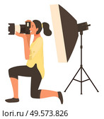 Woman photographer shooting with flash light, photoshoot in studio with spotlight. Happy female holding camera and focusing, taking photo, hobby vector. Photographing with Flash Light, Camera Vector. Стоковая иллюстрация, агентство Ingram Publishing / Фотобанк Лори