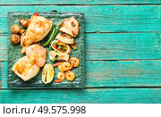 Stuffed squid with shrimps and vegetables.Delicious stuffed cuttlefish.Copy space. Baked squid stuffed. Стоковое фото, агентство Ingram Publishing / Фотобанк Лори