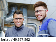 portrait of factory technicians smiling. Стоковое фото, агентство Ingram Publishing / Фотобанк Лори