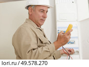 a technician with electricity measurer. Стоковое фото, агентство Ingram Publishing / Фотобанк Лори