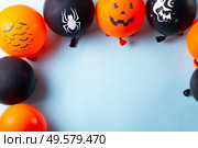 Halloween top view scene with balloons on blue background. Halloween scene with balloons. Стоковое фото, агентство Ingram Publishing / Фотобанк Лори