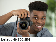 portrait of a happy professional photographer with a camera. Стоковое фото, агентство Ingram Publishing / Фотобанк Лори