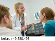 doctor man and woman talking and examining spine mri results. Стоковое фото, агентство Ingram Publishing / Фотобанк Лори