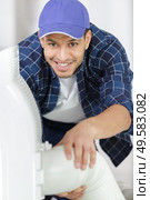 happy male technician repairing industrial air conditioner indoors. Стоковое фото, агентство Ingram Publishing / Фотобанк Лори
