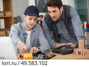 student technician with dismantled telephone. Стоковое фото, агентство Ingram Publishing / Фотобанк Лори