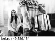 a guy and a girl celebrate the new year togetherin a warm atmosphere and give each other gifts. Стоковое фото, агентство Ingram Publishing / Фотобанк Лори