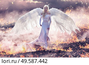 Conceptual portrait of an angel walking on the hell flames. Стоковое фото, агентство Ingram Publishing / Фотобанк Лори