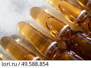 Citrus fruit vitamin c serum oil beauty care, anti aging natural cosmetic, laboratory testing concept, close up view of ampullas. Citrus fruit vitamin c serum oil beauty care. Стоковое фото, агентство Ingram Publishing / Фотобанк Лори