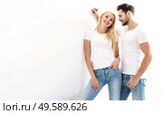 Portrait of a young, attractive couple wearing casual clothes - isolated. Стоковое фото, агентство Ingram Publishing / Фотобанк Лори