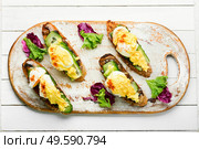 Bruschetta with poached egg,cucumber and fried mushrooms with hollandaise sauce.Tasty eggs benedict. Breakfast with egg benedict. Стоковое фото, агентство Ingram Publishing / Фотобанк Лори