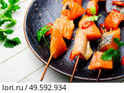 Appetizing pieces of dried salted salmon on skewers.Salty red fish. Dried fish salmon. Стоковое фото, агентство Ingram Publishing / Фотобанк Лори