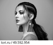 Brunette girl with perfect makeup. Beautiful model woman with curly hairstyle. Care and beauty hair products. Lady with braided hair. Model with jewelry. Black and white photo. Стоковое фото, агентство Ingram Publishing / Фотобанк Лори