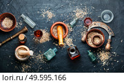 Dried eleutherococcus in herbal medicine.Tinctures from medicinal herbs.Healing herbs. Eleutherococcus in herbal medicine. Стоковое фото, агентство Ingram Publishing / Фотобанк Лори