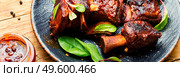 Tasty BBQ beef ribs seasoned with spicy sauce.Long banner. Roasted beef brisket on the ribs. Стоковое фото, агентство Ingram Publishing / Фотобанк Лори