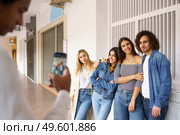 Multi-ethnic group of friends taking photos with a smartphone in the street. Young people having fun together.. Multi-ethnic group of friends taking photos with a smartphone in the street. Стоковое фото, агентство Ingram Publishing / Фотобанк Лори