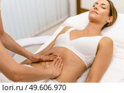 Middle-aged woman having a belly massage in a beauty salon. Body care treatment in a beauty centre.. Middle-aged woman having a belly massage in a beauty salon. Стоковое фото, агентство Ingram Publishing / Фотобанк Лори