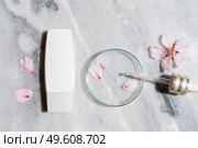 Retinol and almond oil serum beauty care in white tube, anti aging natural cosmetic, laboratory testing concept. Retinol and almond oil serum oil beauty care. Стоковое фото, агентство Ingram Publishing / Фотобанк Лори