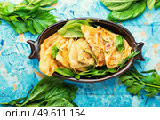 Unleavened dough pie stuffed with fresh herbs. Qutabs or kutab. Azeyrbajan food. Azerbaijani qutab with greens and cheese. Стоковое фото, агентство Ingram Publishing / Фотобанк Лори