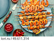 Appetizing shrimps fried on a wooden stick.Grilled scampi. Grilled shrimp on a skewer. Стоковое фото, агентство Ingram Publishing / Фотобанк Лори