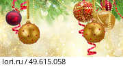 Red and golden christmas balls garland and evergreen fir tree on glowing golden background banner. Red christmas balls. Стоковое фото, агентство Ingram Publishing / Фотобанк Лори
