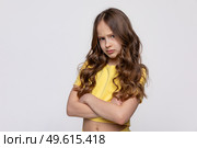 Negative human emotions, reactions and feelings. Isolated shot of moody displeased angry little girl crossing arms on her chest, pouting lips, having offended facial expression on white background. Стоковое фото, фотограф Ирина Михайличенко / Фотобанк Лори