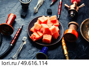 Aromatic smoking hookah with watermelon flavored tobacco. Mouthpiece for smoking hookah. Стоковое фото, агентство Ingram Publishing / Фотобанк Лори