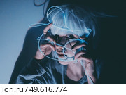 Weird dystopian theme portrait with blue neon lights. Стоковое фото, агентство Ingram Publishing / Фотобанк Лори