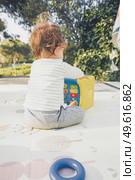 Backview of a baby playing in nature. Стоковое фото, агентство Ingram Publishing / Фотобанк Лори