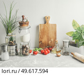 Baking background of savory with kitchen utensils, rolling pin , flour, ingredients and fresh vegetables at white wall . Sustainable lifestyle. Front view. Стоковое фото, агентство Ingram Publishing / Фотобанк Лори