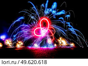 fiery pieces of a fire show against a dark sky and thunderstorms. Стоковое фото, агентство Ingram Publishing / Фотобанк Лори