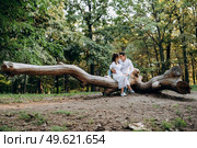 guy and a girl walk along the paths of a forest park between tall trees. Стоковое фото, агентство Ingram Publishing / Фотобанк Лори