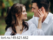 guy and a girl walk along the paths of a forest park between tall trees. Стоковое фото, агентство Ingram Publishing / Фотобанк Лори