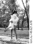 guy and a girl walk along the paths of a forest park between tall trees. Стоковое фото, агентство Ingram Publishing / Фотобанк Лори
