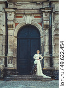 Girl in an old dress with ruffles and a big dark dog. Стоковое фото, агентство Ingram Publishing / Фотобанк Лори