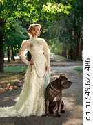 Girl in an old dress with ruffles and a big dark dog. Стоковое фото, агентство Ingram Publishing / Фотобанк Лори