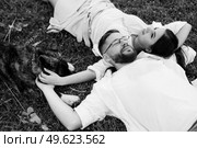 Big dog for a walk with a guy and a girl on the green prairie. Стоковое фото, агентство Ingram Publishing / Фотобанк Лори